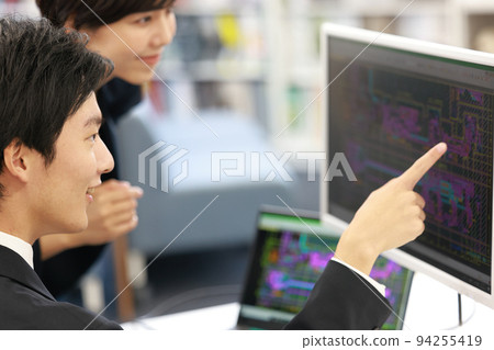 Male designer checking whether the design meets the specifications while looking at the CAD with seniors_1 94255419