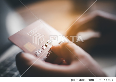Close up hands holding credit card, typing on the keyboard of laptop, online shopping. Close up hands holding credit card, typing on the keyboard of laptop, online shopping. 94255705