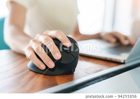 woman hand using computer ergonomic mouse, prevention wrist pain because working long time. De Quervain s tenosynovitis, Intersection Symptom, Carpal Tunnel Syndrome or Office syndrome concept woman hand using computer ergonomic mouse, prevention wrist pain because working long time. De Quervain s tenosynovitis, Intersection Symptom, Carpal Tunnel Syndrome or Office syndrome concept 94255856