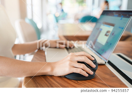 woman hand using computer ergonomic mouse, prevention wrist pain because working long time. De Quervain s tenosynovitis, Intersection Symptom, Carpal Tunnel Syndrome or Office syndrome concept 94255857
