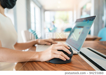 woman hand using computer ergonomic mouse, prevention wrist pain because working long time. De Quervain s tenosynovitis, Intersection Symptom, Carpal Tunnel Syndrome or Office syndrome concept woman hand using computer ergonomic mouse, prevention wrist pain because working long time. De Quervain s tenosynovitis, Intersection Symptom, Carpal Tunnel Syndrome or Office syndrome concept 94255860