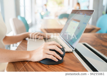 woman hand using computer ergonomic mouse, prevention wrist pain because working long time. De Quervain s tenosynovitis, Intersection Symptom, Carpal Tunnel Syndrome or Office syndrome concept 94255861
