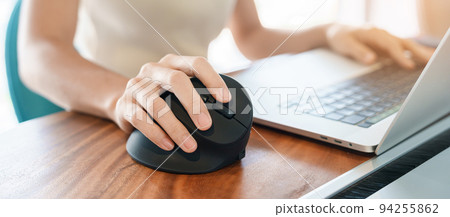 woman hand using computer ergonomic mouse, prevention wrist pain because working long time. De Quervain s tenosynovitis, Intersection Symptom, Carpal Tunnel Syndrome or Office syndrome concept woman hand using computer ergonomic mouse, prevention wrist pain because working long time. De Quervain s tenosynovitis, Intersection Symptom, Carpal Tunnel Syndrome or Office syndrome concept 94255862