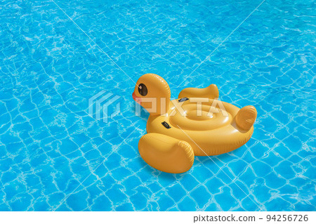 Duck shaped inflatable ring on swimming pool. Concept for summer day 94256726