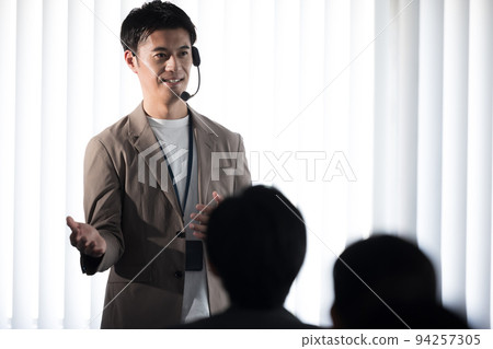 Seminar speaker A man speaking with a head microphone Seminar speaker A man speaking with a head microphone 94257305