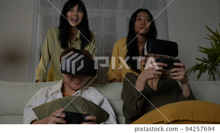 Holiday concept of 4k Resolution. Asian woman playing video game using vr in living room. virtual reality technology. 94257694