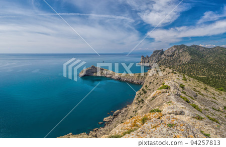 Beautiful seascape, panorama of cape Kapchik to the Galitsin Trail and blue bay of the Black Sea. Sudak, New World. Landscape of the sea coast. The concept of calmness, silence and unity with nature. Beautiful seascape, panorama of cape Kapchik to the Galitsin Trail and blue bay of the Black Sea. Sudak, New World. Landscape of the sea coast. The concept of calmness, silence and unity with nature. 94257813