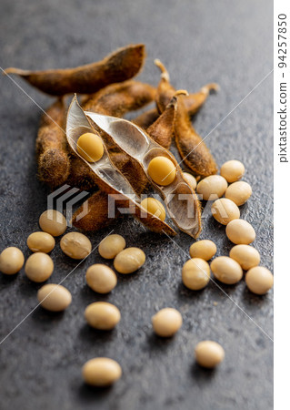 Soy beans. Dried soybean pod on black table. 94257850