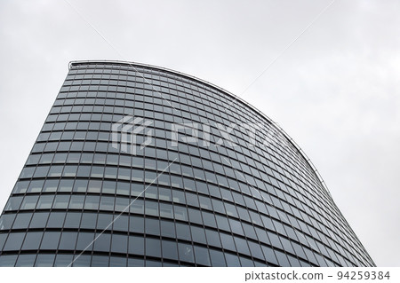 Mirrored windows on a tall modern building Mirrored windows on a tall modern building 94259384