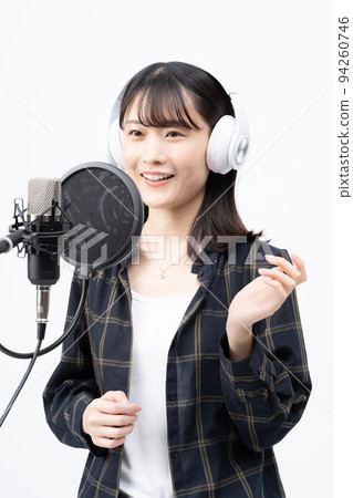 Young woman singing with white headphones 94260746