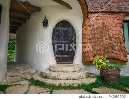 The Clay Castle from the Valley of Fairies, a touristic complex in Transylvania, Romania. Closeup view to a tiny entrance door, fantasy hobbit house from tales 94260892