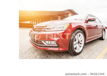 Side view of cherry red business sedan car 94261344