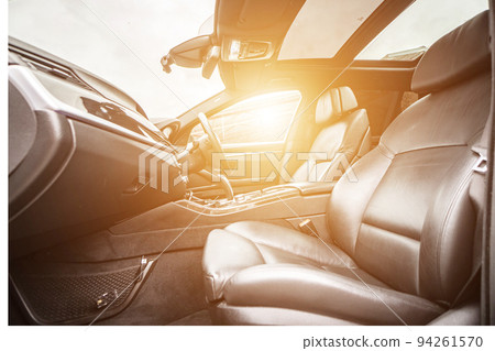 Car inside. Interior of prestige modern car. Comfortable leather seats. Black cockpit with on isolated white background. Car inside. Interior of prestige modern car. Comfortable leather seats. Black cockpit with on isolated white background. 94261570