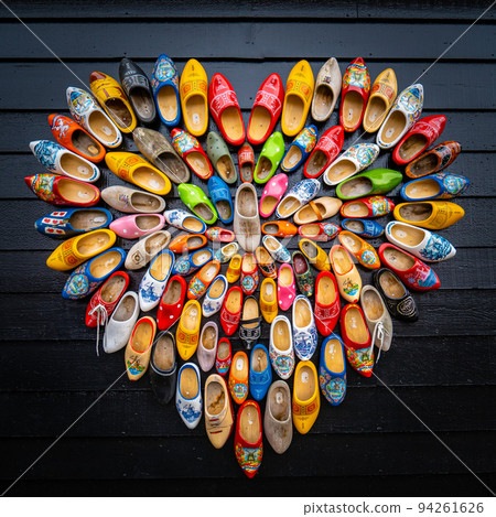 Clogs for sale at a Dutch retail shop. Wooden shoes are a well know traditional souvenir from Holland Clogs for sale at a Dutch retail shop. Wooden shoes are a well know traditional souvenir from Holland 94261626