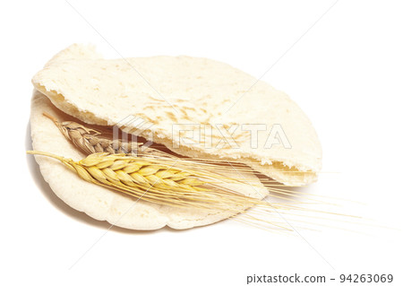 Pita bread with wheat ears isolated on white background. National cuisine. Healthy eating. Vegetarian food. Pita bread with wheat ears isolated on white background. National cuisine. Healthy eating. Vegetarian food. 94263069