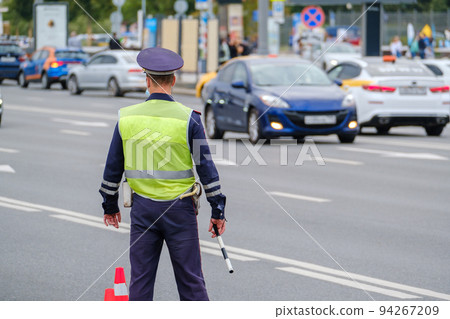 Traffic officer standing near road Traffic officer standing near road 94267209