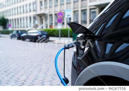 Electromobile charging plug is inserted into vehicle charging socket. Electromobile charging plug is inserted into vehicle charging socket. 94267556