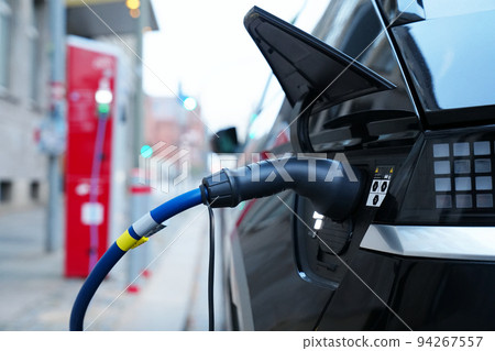 Electromobile charging plug is inserted into vehicle charging socket. Electromobile charging plug is inserted into vehicle charging socket. 94267557