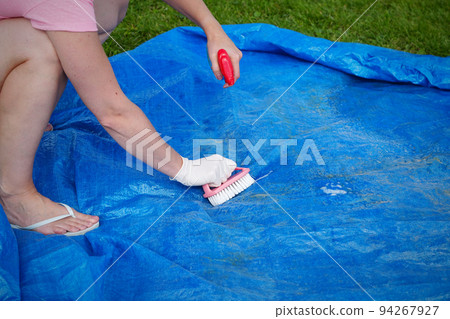 Cleaning pvc inflatable swimming pool, Cleaning the dirty empty pool of algae Cleaning pvc inflatable swimming pool, Cleaning the dirty empty pool of algae 94267927