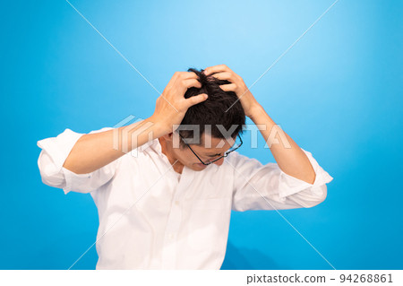A man holding his head and lamenting his failure A man holding his head and lamenting his failure 94268861