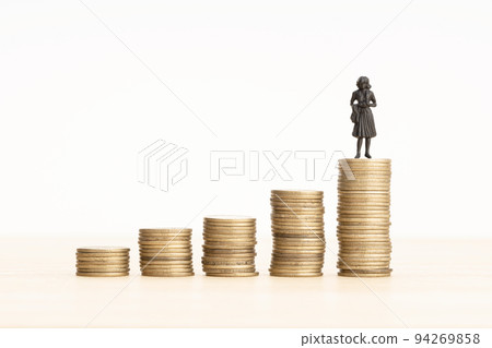 Wealth growth process concept. Woman figurine on Rising Coin stacks. Copy space Wealth growth process concept. Woman figurine on Rising Coin stacks. Copy space 94269858