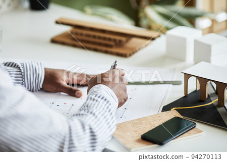 Architect drawing blueprint at table Architect drawing blueprint at table 94270113