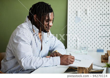 Man working with construction project 94270114