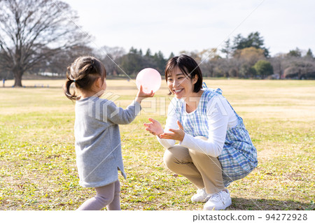 Kindergarteners and nursery teachers playing on the lawn square in the park Kindergarteners and nursery teachers playing on the lawn square in the park 94272928