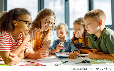 Teacher and students on lesson together at school 94275129