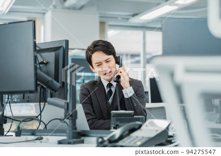 A man answering a complaint phone A man answering a complaint phone 94275547