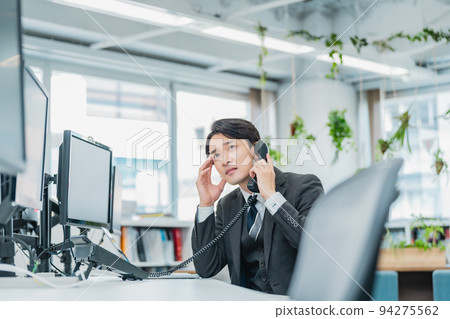 A man answering a complaint phone A man answering a complaint phone 94275562