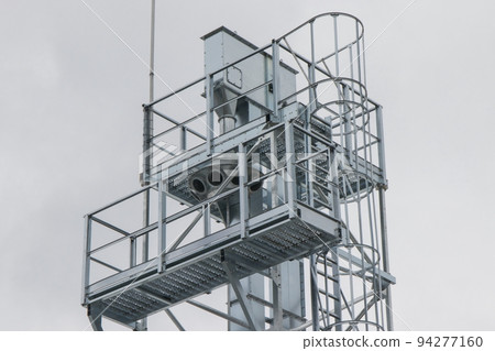 Ladder on silo for storage grain after harvest. Detail of agricultural equipments Ladder on silo for storage grain after harvest. Detail of agricultural equipments 94277160