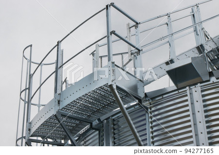 Ladder on silo for storage grain after harvest. Detail of agricultural equipments Ladder on silo for storage grain after harvest. Detail of agricultural equipments 94277165