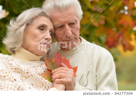 Portrait of a sad seniors in autumn park Portrait of a sad seniors in autumn park 94277304