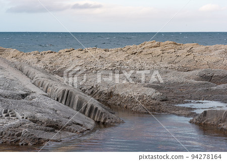 coastal seascape with beautiful columnar basalt rocks at low tide coastal seascape with beautiful columnar basalt rocks at low tide 94278164