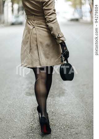 A girl in dark stockings and black stiletto - Stock Photo