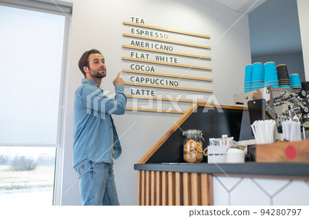 Cafe owner thinking over new idea for the menu Cafe owner thinking over new idea for the menu 94280797