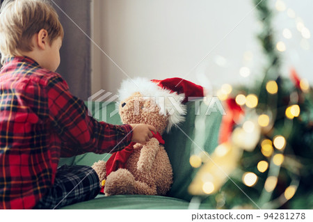 cute little boy dressing up teddy bear cute little boy dressing up teddy bear 94281278