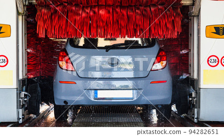 Car wash background automatic carwash. Brush washer clean blue auto car on automatic carwash station. Automated car washing service. 94282651