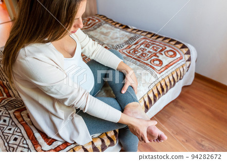Pregnancy pain leg woman. Pregnant girl have leg disease, ankle pain doing health massage exercise. Foot swelling during pregnancy. Pregnancy pain leg woman. Pregnant girl have leg disease, ankle pain doing health massage exercise. Foot swelling during pregnancy. 94282672