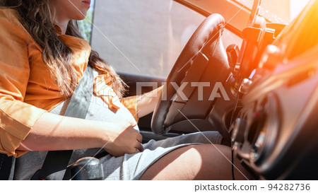 Pregnant woman driver. Beautiful smiling pregnancy woman driving car. Safety pregnant young mother drive concept. 94282736