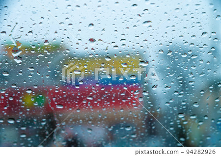 Focus on rain drops, indoor photography, blurred background. Seasonal rain, abstract Focus on rain drops, indoor photography, blurred background. Seasonal rain, abstract 94282926