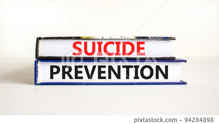 Suicide prevention symbol. Concept words Suicide prevention on books. Beautiful white table white background. Psychological and suicide prevention concept. Copy space. Suicide prevention symbol. Concept words Suicide prevention on books. Beautiful white table white background. Psychological and suicide prevention concept. Copy space. 94284898