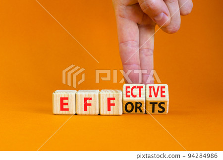 Effective efforts symbol. Concept words Effective efforts on wooden cubes. Businessman hand. Beautiful orange table orange background. Business effective efforts concept. Copy space. 94284986