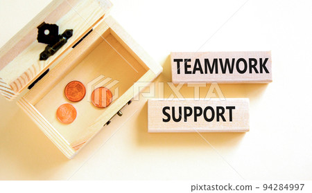 Teamwork support symbol. Concept words Teamwork support on wooden blocks on a beautiful white table white background. Wooden chest with coins. Business and teamwork support concept. Copy space. Teamwork support symbol. Concept words Teamwork support on wooden blocks on a beautiful white table white background. Wooden chest with coins. Business and teamwork support concept. Copy space. 94284997