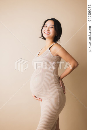 Pregnant woman walking on green road 94286081