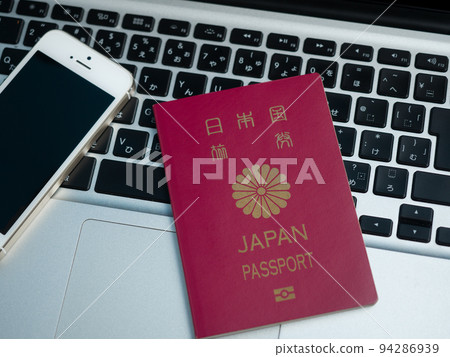 computer, smartphone and passport 94286939