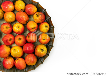 Ripe red small apples Ranetka on a metal plate, on a white background. Isolated background Ripe red small apples Ranetka on a metal plate, on a white background. Isolated background 94286953