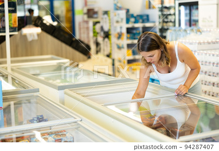 Portrait of positive girl looking frozen convenience foods 94287407