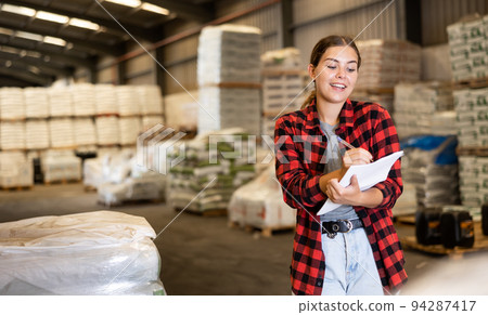 Portrait of young woman construction material storage worker Portrait of young woman construction material storage worker 94287417